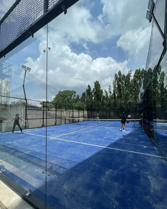 Players on a blue court under the sky