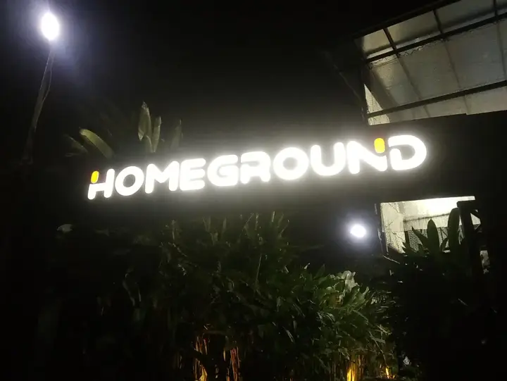 The Homeground sign lit at night