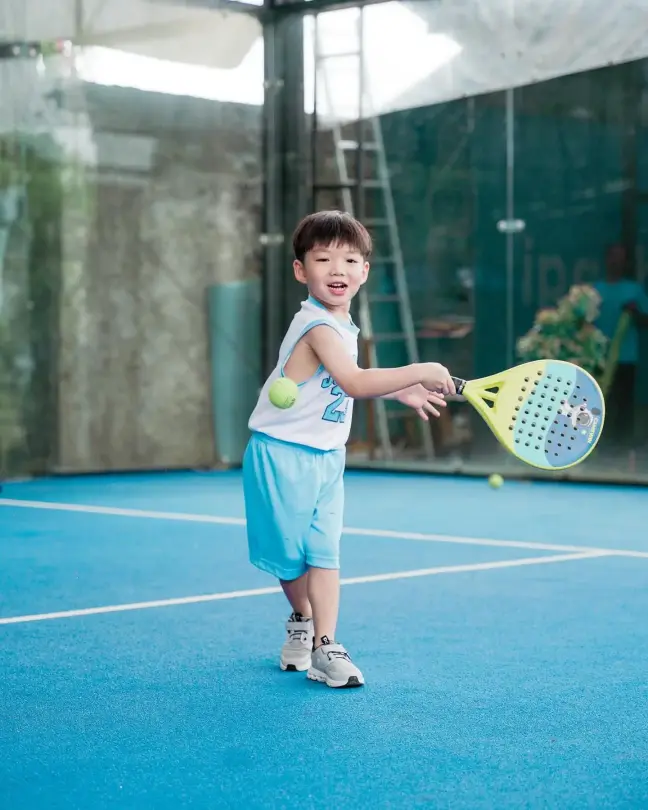 A young boy hitting a forehand